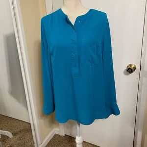 Turquoise blouse worn casually or at work